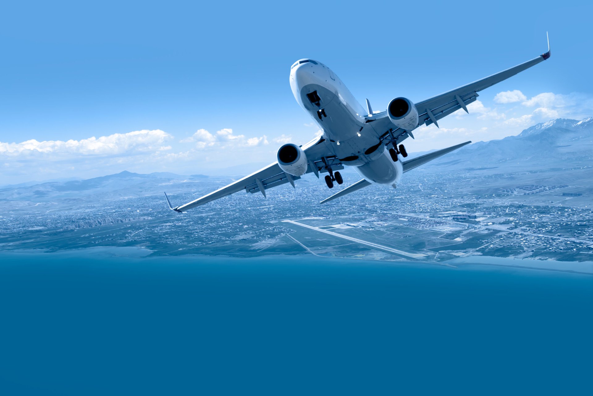 Airplane taking off from airport - Passenger airplane is flying over amazing mountains and sea - Travel by air transport